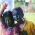 Peserta anak-anak Holi Hai yang penuh dengan warna di wajahnya